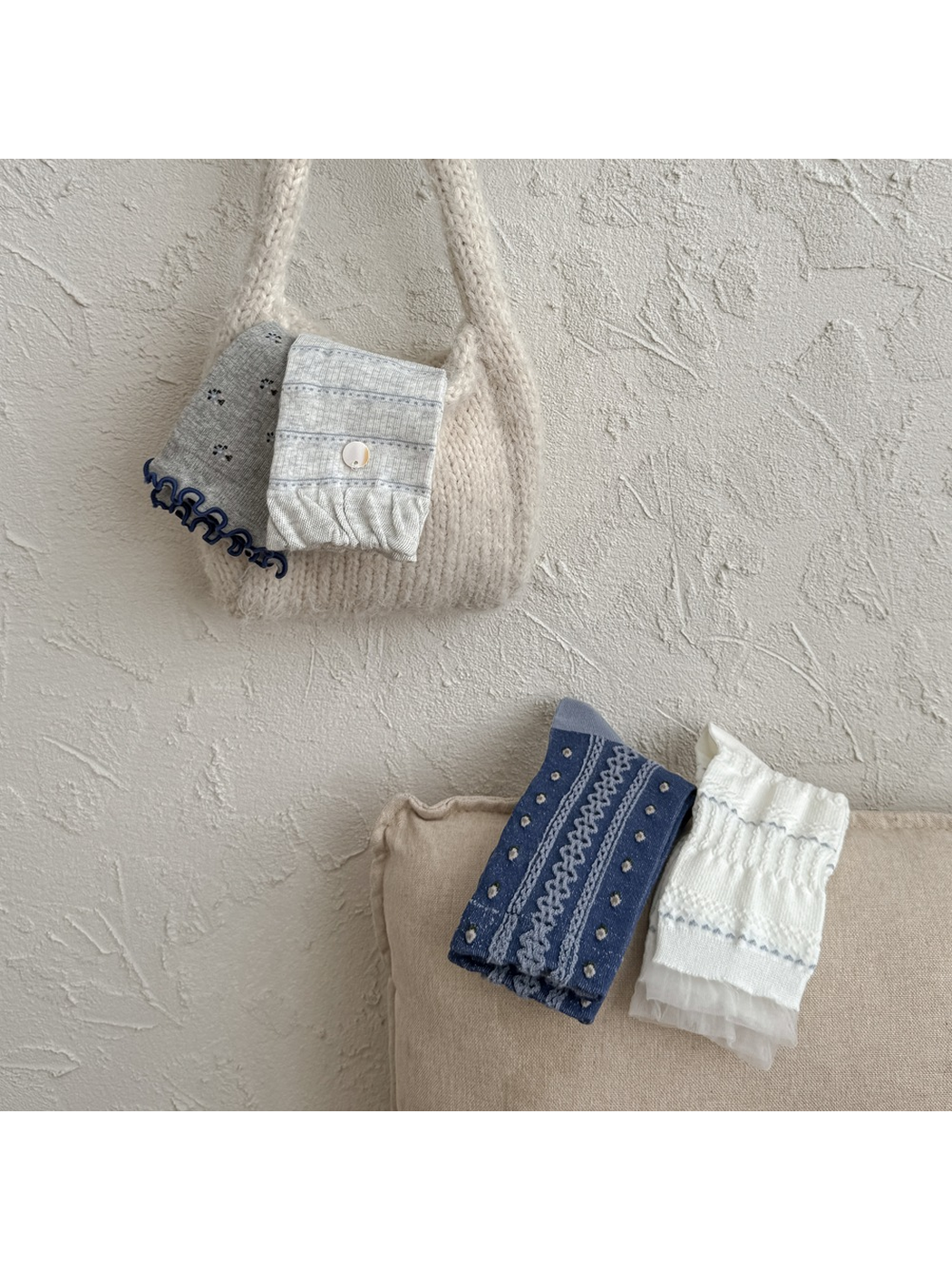 Four patterned crew sock styles arranged with a small knit bag