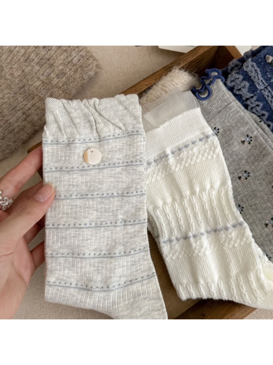 Close-up of striped, pointelle and floral sock cuff details