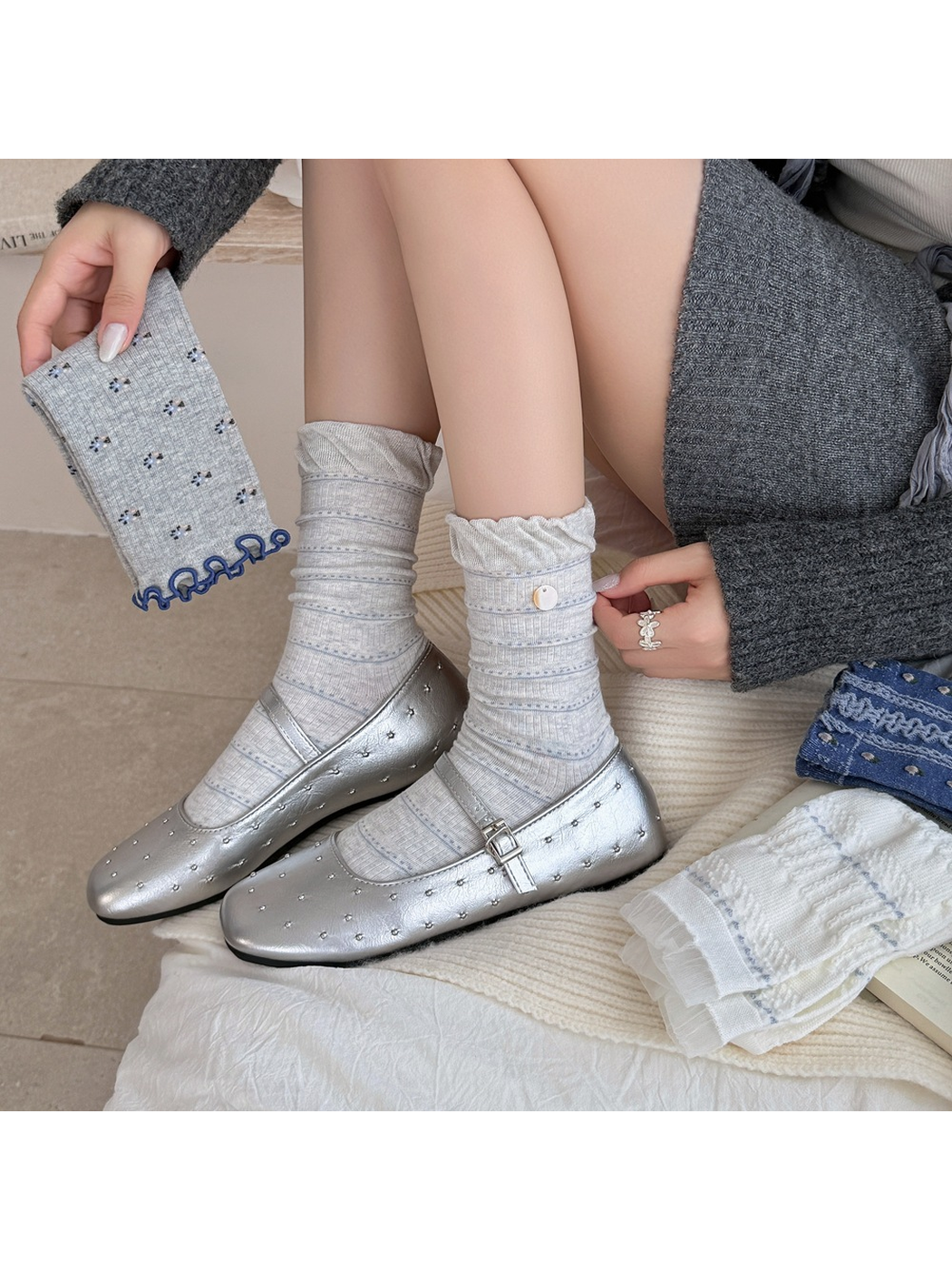 Light gray striped crew socks worn with silver flats