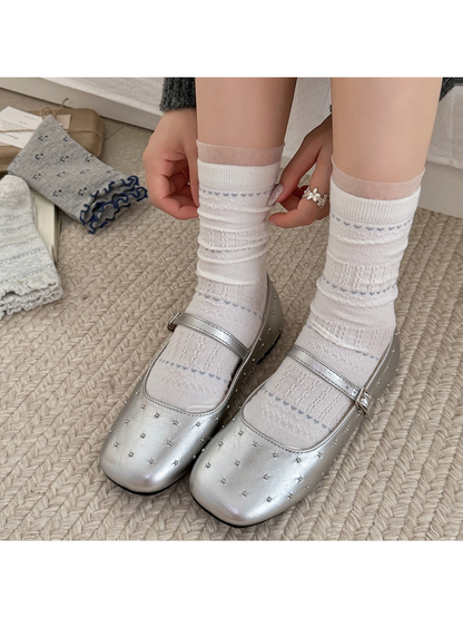 White pointelle crew socks worn with silver flats