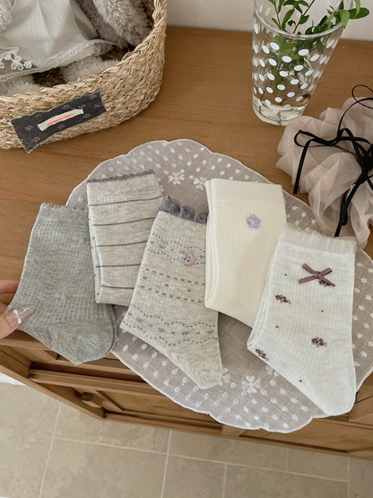 Five gray and white crew sock designs arranged together