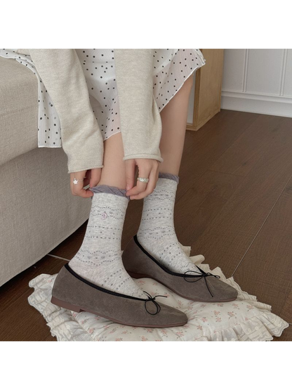 Gray crescent-motif crew socks styled with taupe flats