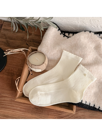 Ivory ribbed crew socks with a pearl-like cuff accent