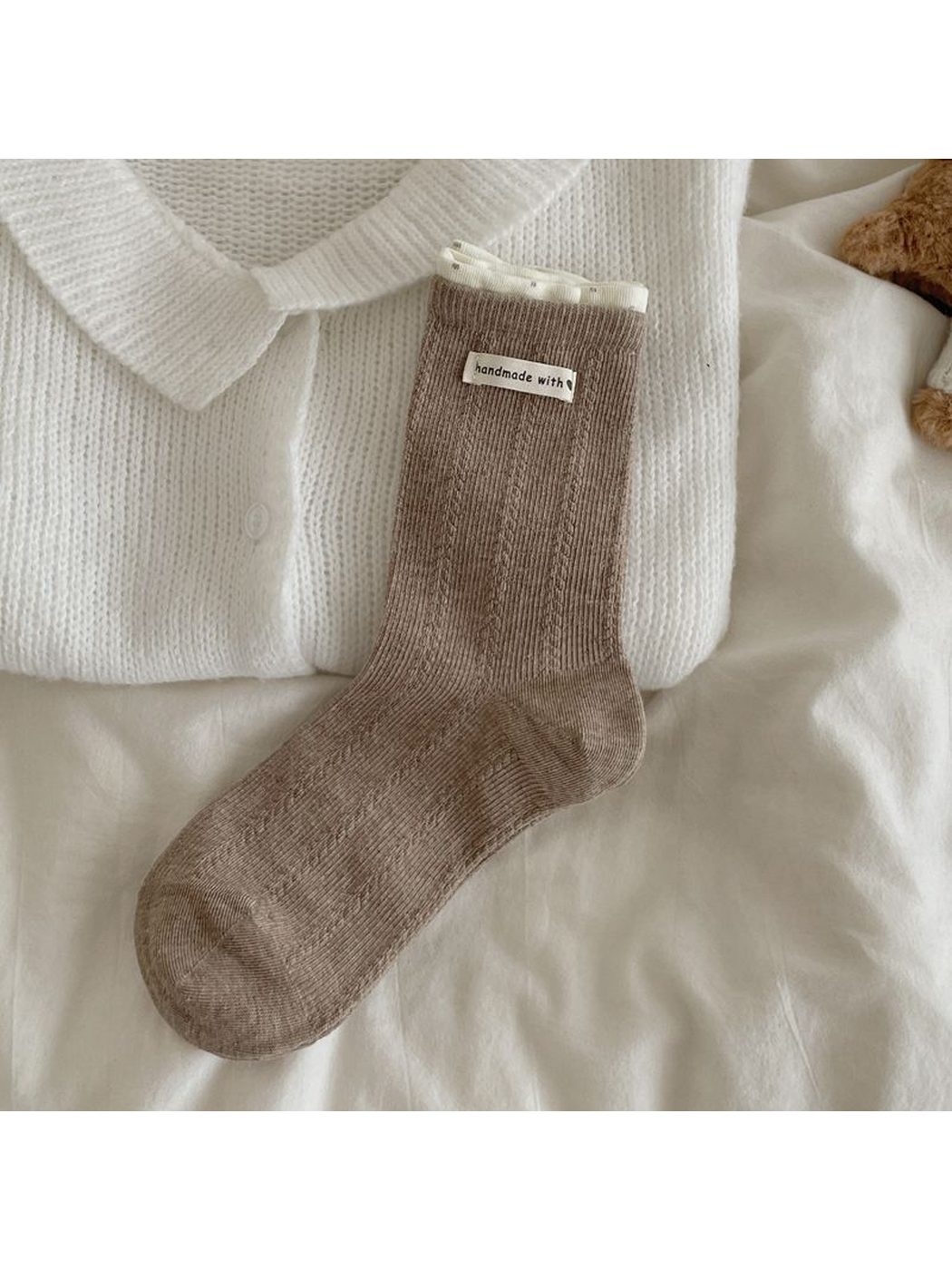 Light coffee ribbed crew sock with cream folded cuff edge and small label