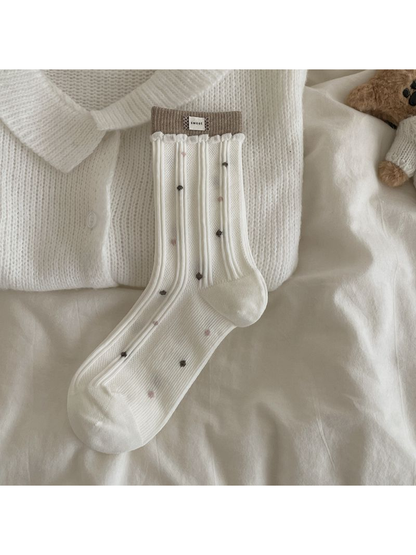 Ivory ribbed crew sock with scattered brown and pink dots and contrasting cuff