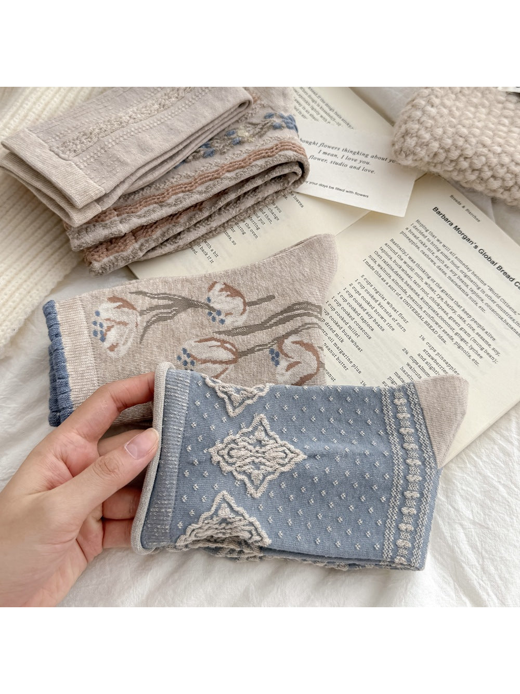Close-up of blue diamond and beige tulip sock patterns