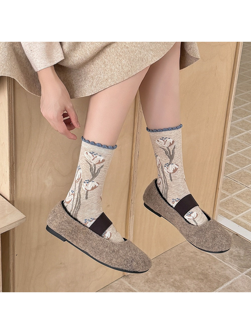 Beige tulip-pattern crew socks worn with taupe strap shoes