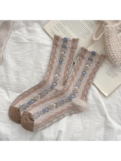 Beige crew socks with raised blue floral trails and textured stripes