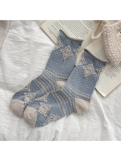 Gray-blue crew socks with raised cream diamonds and patterned bands