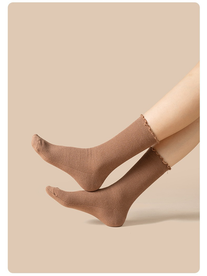 Light coffee ribbed crew socks worn in a raised-leg side view
