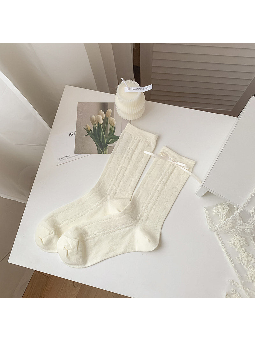 Ivory heart-pattern crew socks with a ribbon bow