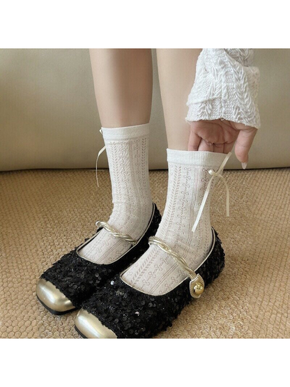 Ivory textured crew socks styled with black sequined shoes