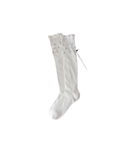 White knee-high socks with ribbing, dotted upper panels and cuff ties