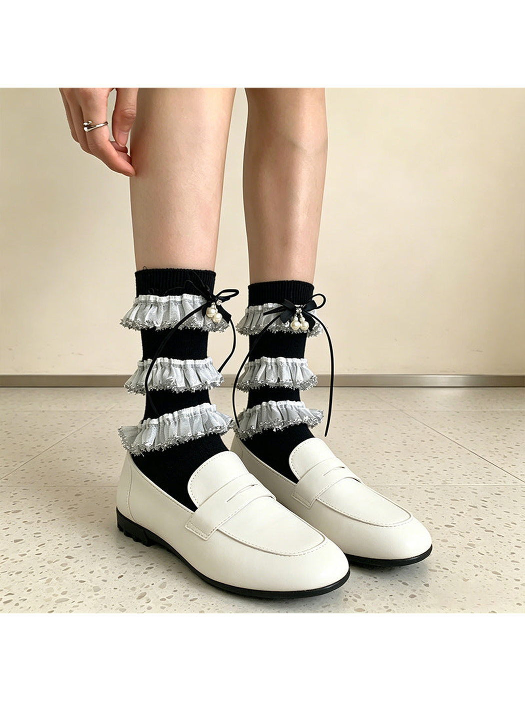 Black tiered-ruffle socks with ribbon bows and bead accents