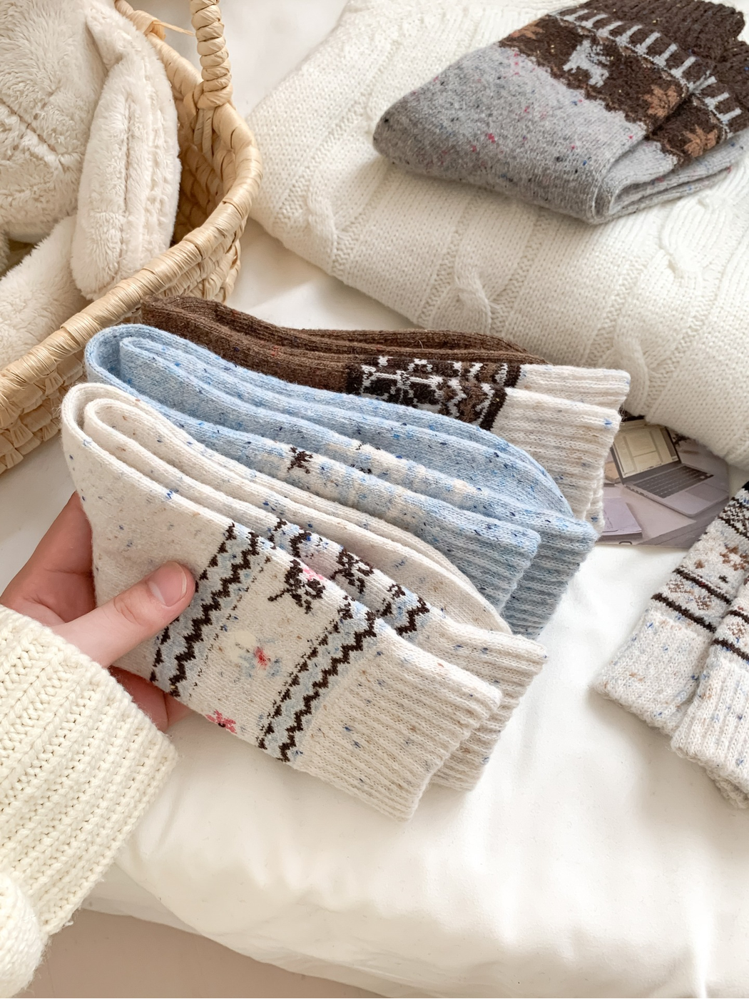 Folded patterned socks showing ribbed cuffs and knit texture
