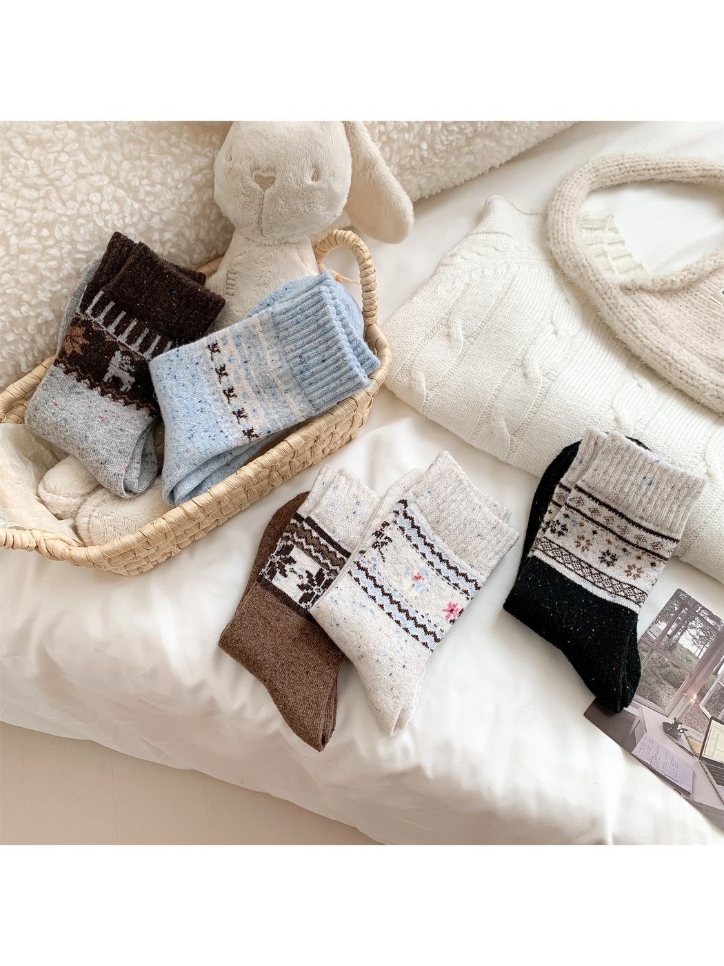 Black, ivory, blue, brown and gray patterned crew socks arranged together