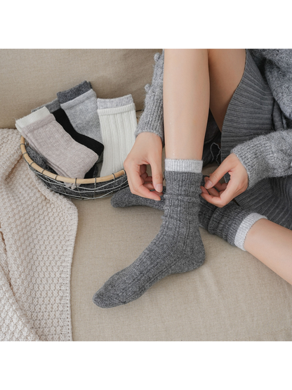 Dark gray ribbed crew socks worn scrunched with the light gray cuff exposed