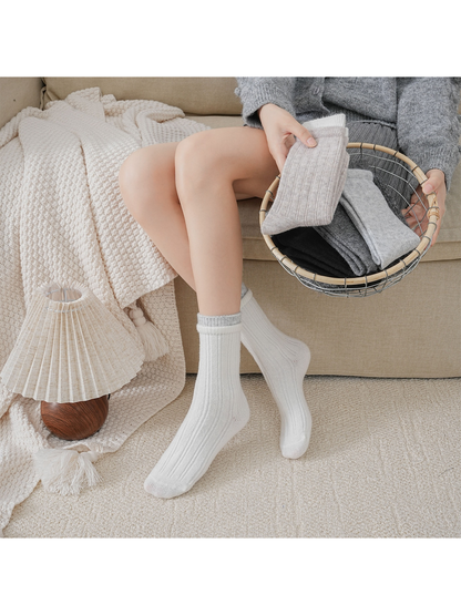 Ivory ribbed crew socks worn at full length beside folded color options