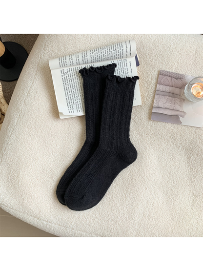 Black ribbed crew socks with ruffled cuffs