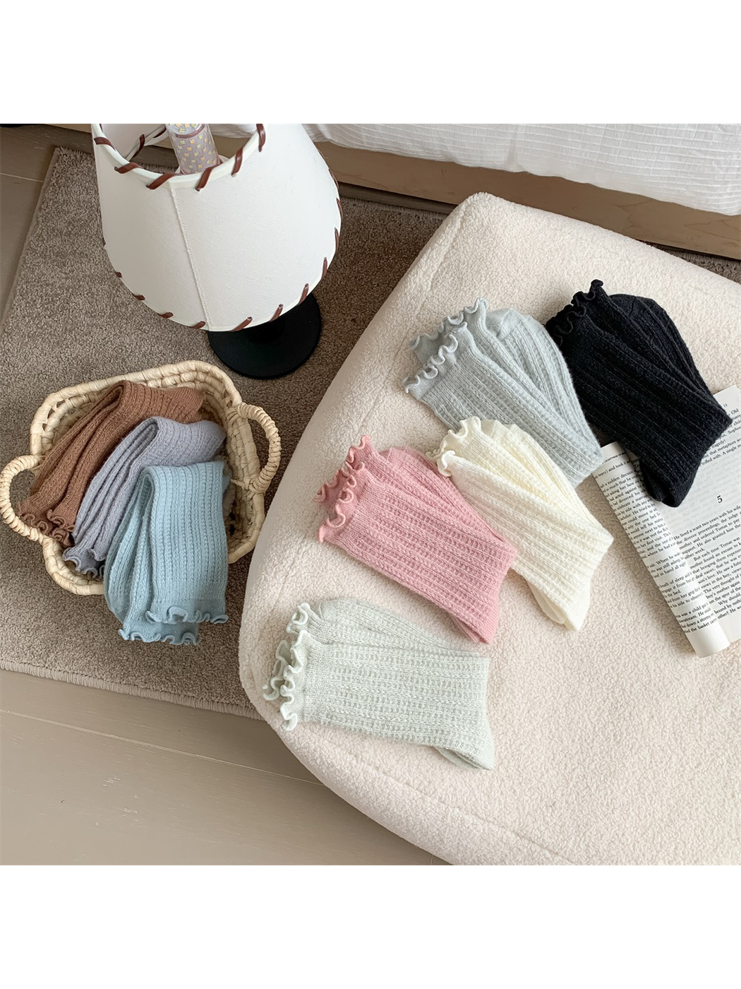 Assorted ribbed ruffle-cuff socks arranged in a home setting
