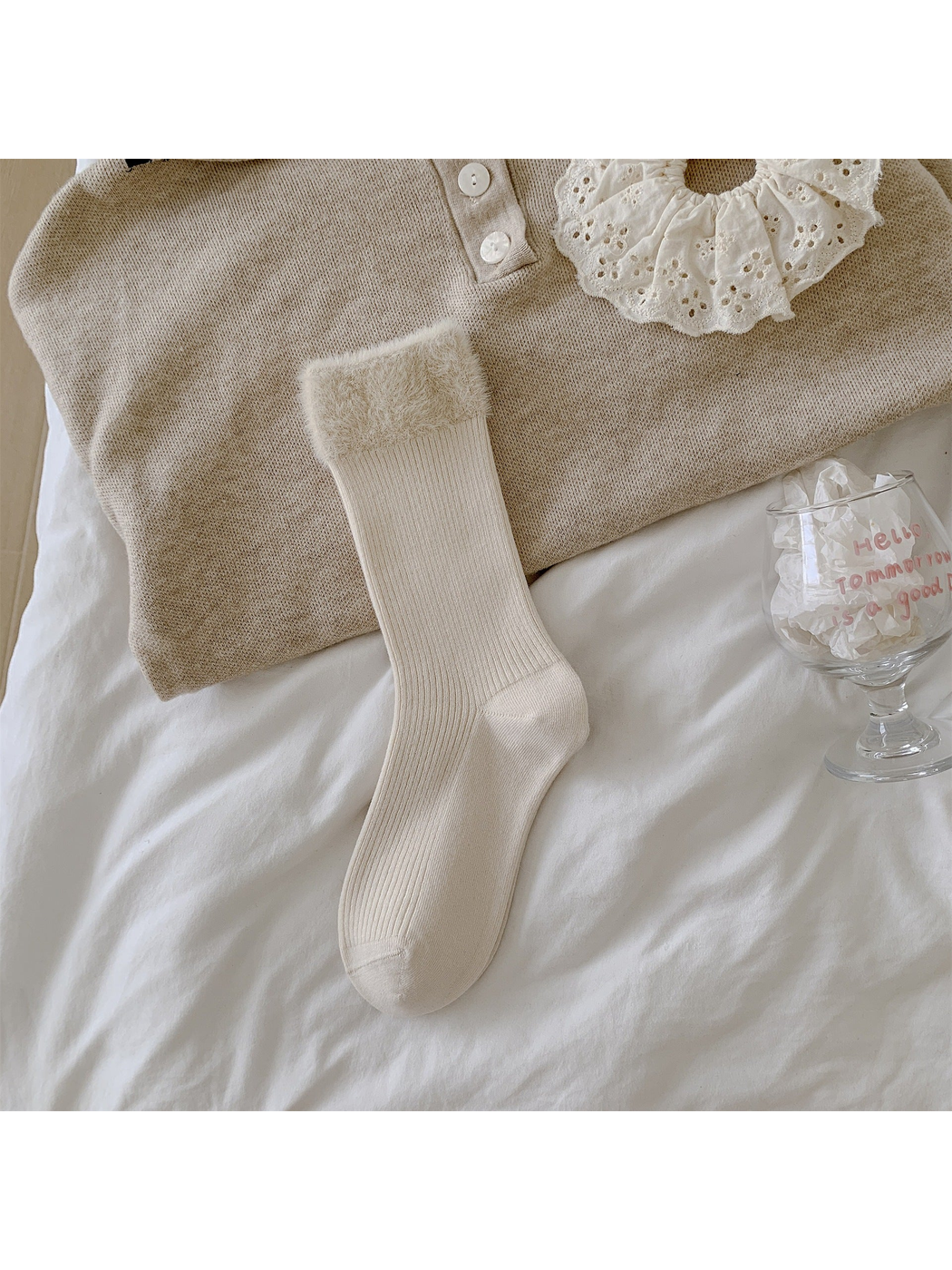 Cream ribbed crew sock with a wide fuzzy cuff laid flat