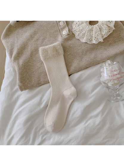 Cream ribbed crew sock with a wide fuzzy cuff laid flat