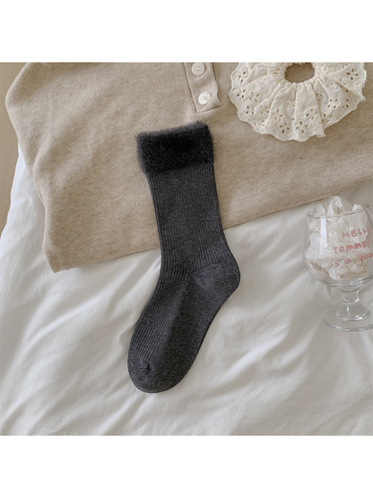 Dark gray ribbed crew sock with a wide fuzzy cuff laid flat