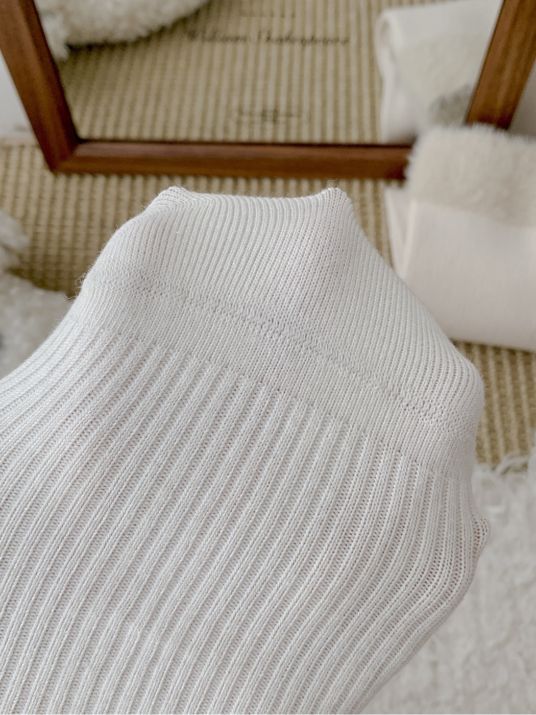 Close-up of the ribbed knit and toe construction on a white sock