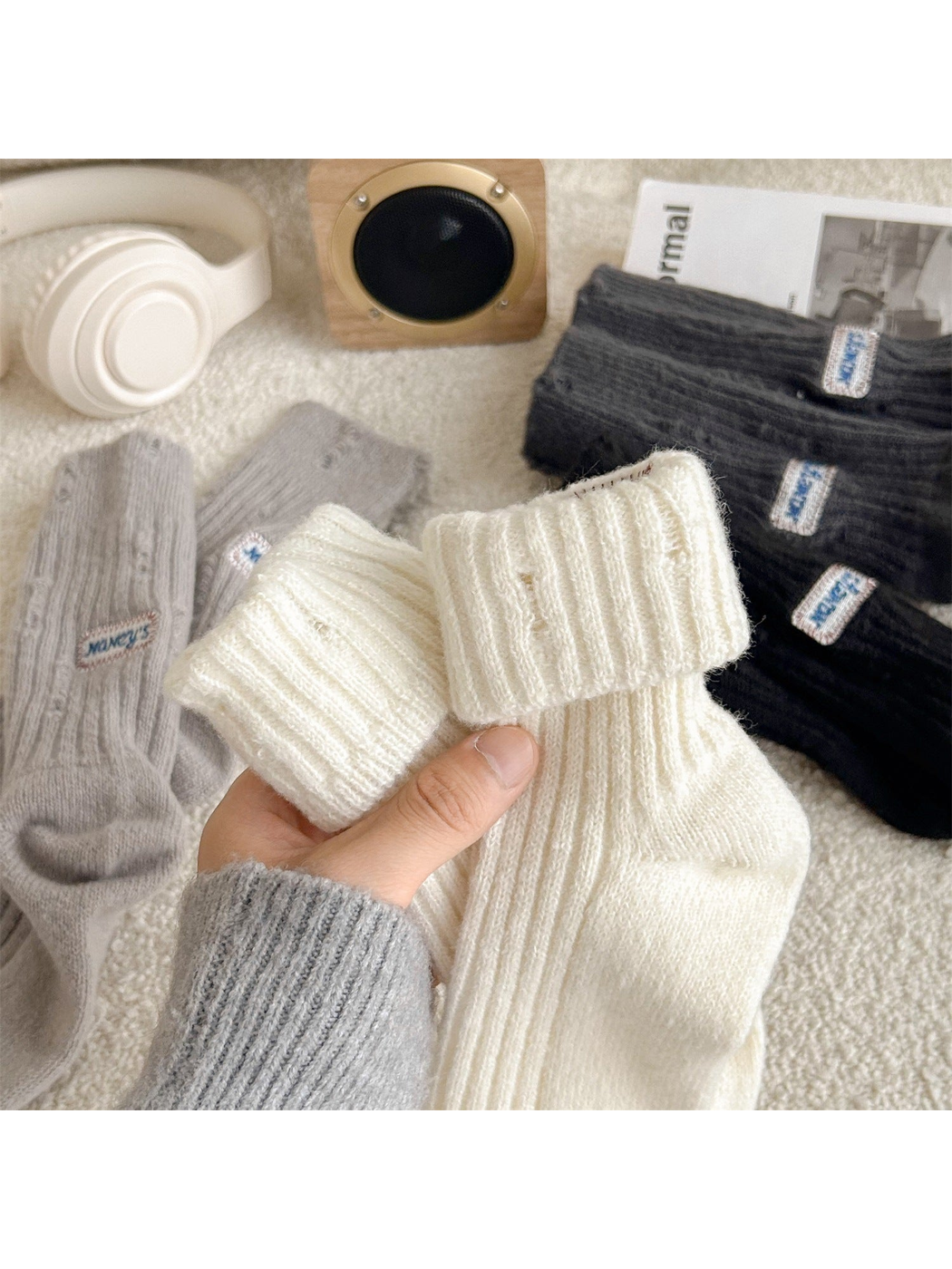 Close-up of the wide folded ribbed cuff on ivory crew socks