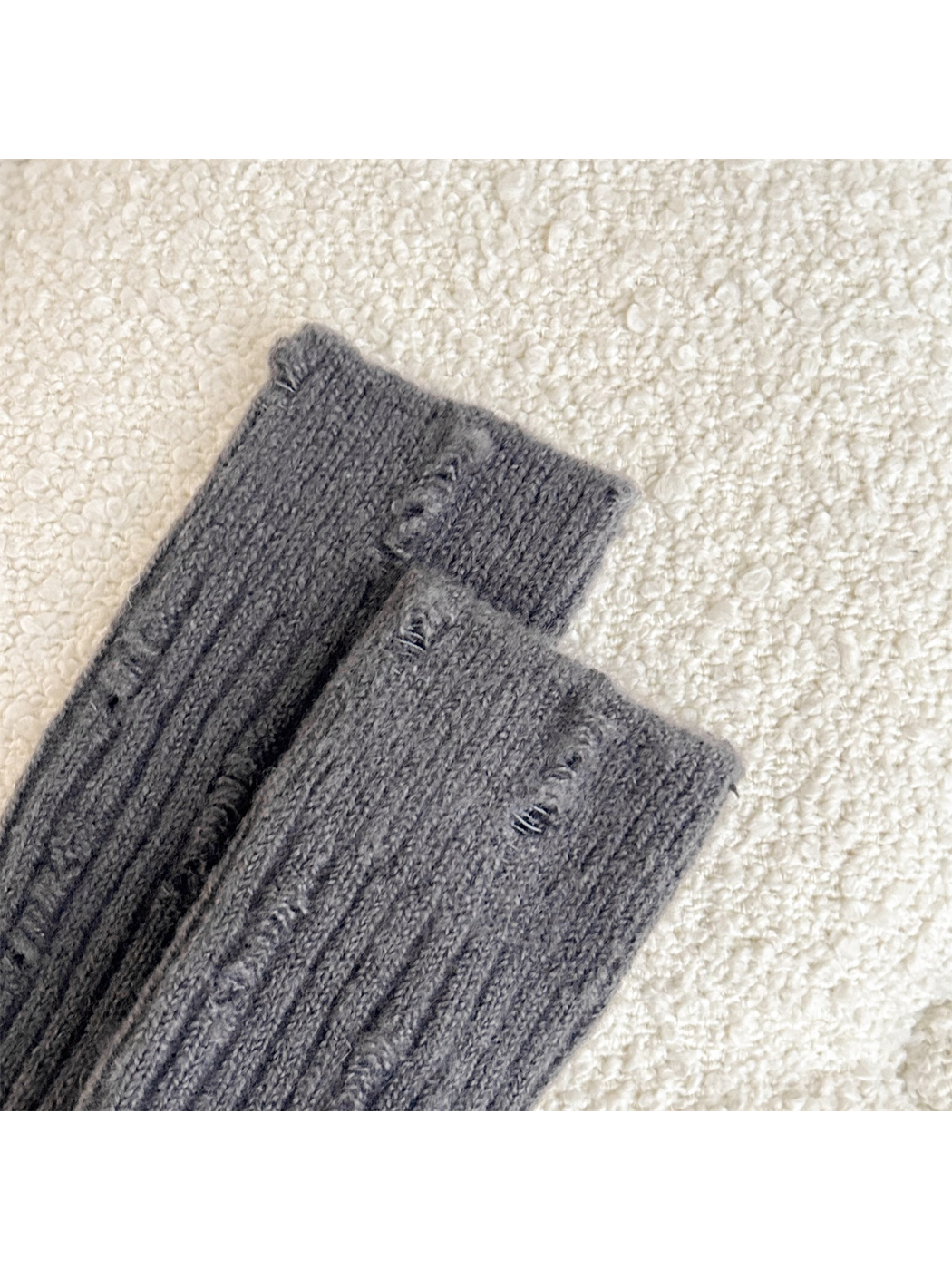 Close-up of distressed laddered openings along the vertical ribbing