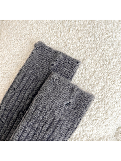 Close-up of distressed laddered openings along the vertical ribbing