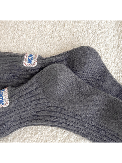 Close-up of the shaped heel and ribbed leg on dark gray crew socks