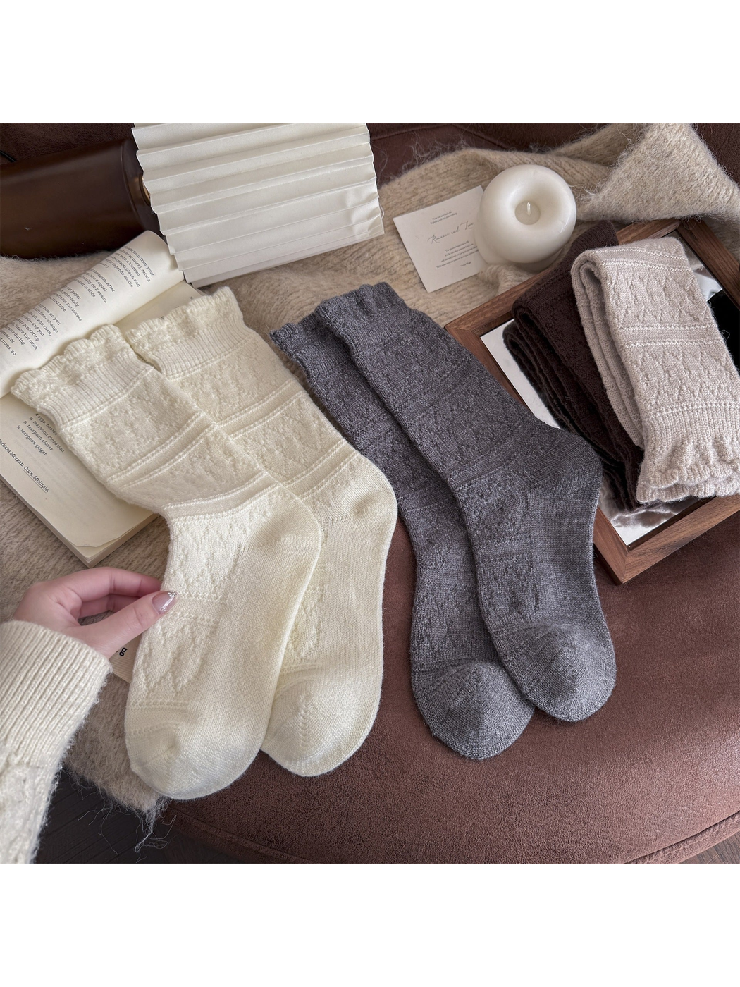Cream, gray, brown and black patterned crew socks arranged in a flat lay