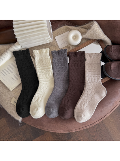 Five colors of patterned crew socks displayed side by side