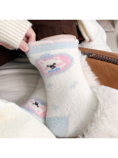 Pastel round dog motif crew sock worn with a fuzzy slipper