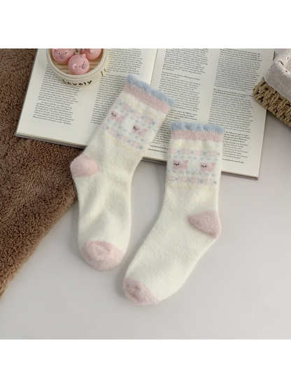 Cream fuzzy crew socks with two small dog motifs and pink toes
