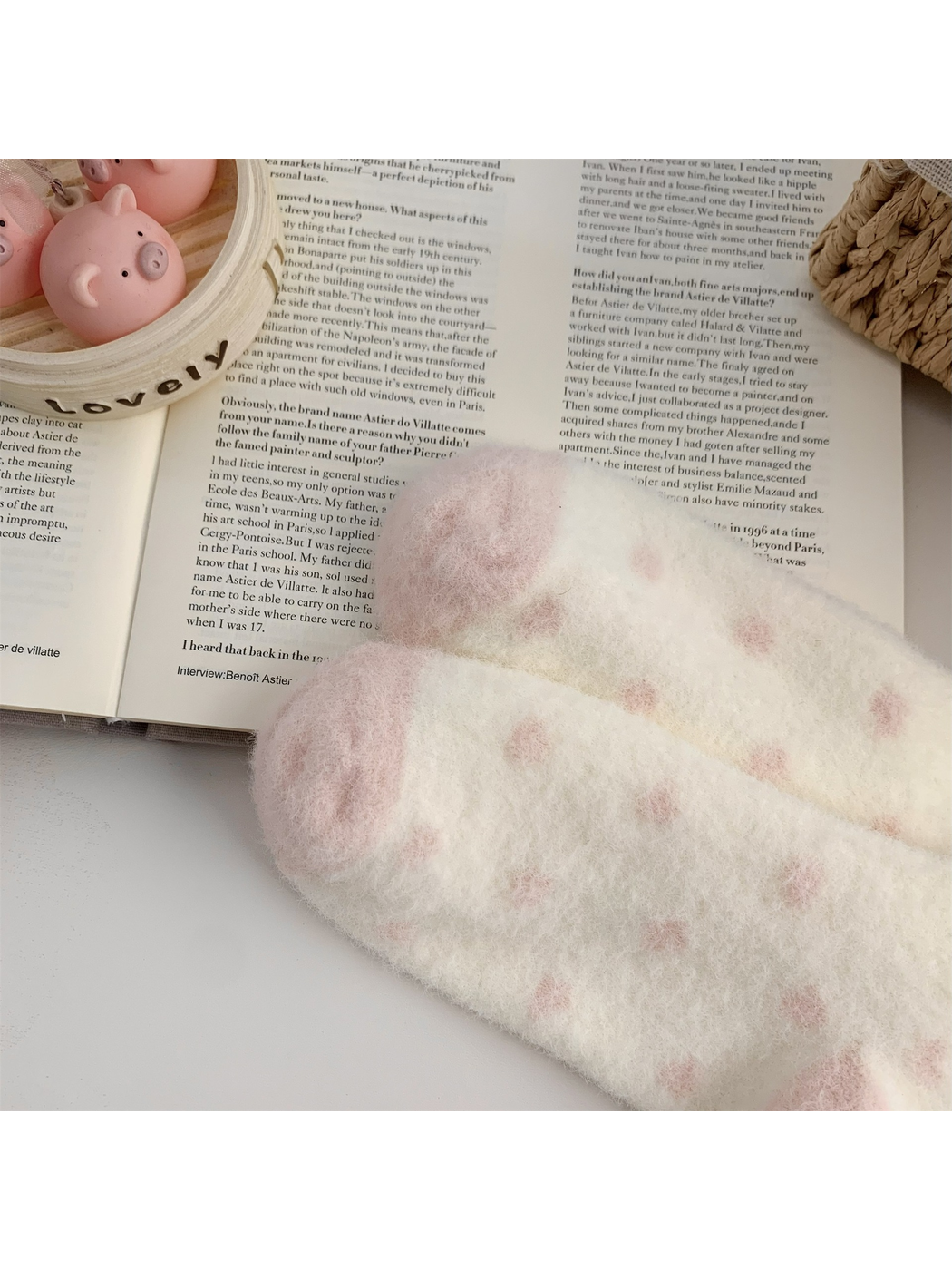 Close-up of the cream fuzzy sock surface with pink dot pattern and contrasting heel