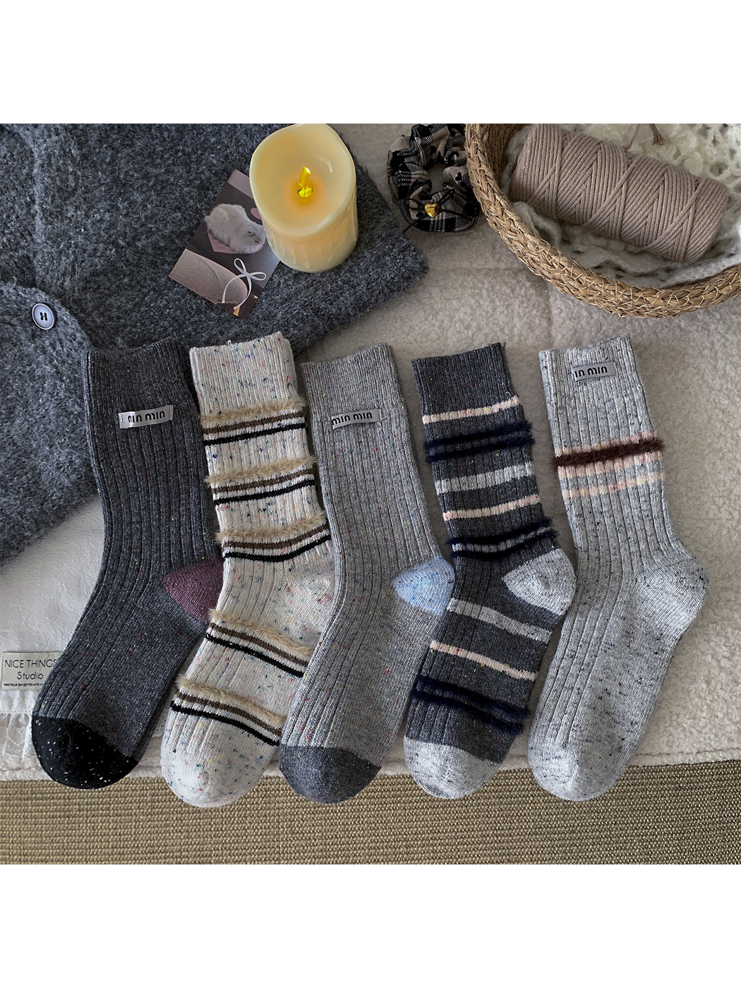 Five gray and ivory crew sock styles displayed together