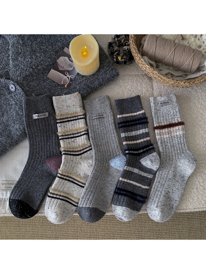 Five gray and ivory crew sock styles displayed together