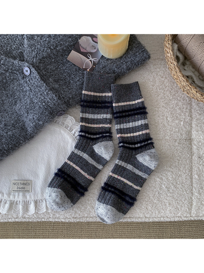 Dark gray crew socks with repeating gray and pink fuzzy stripes