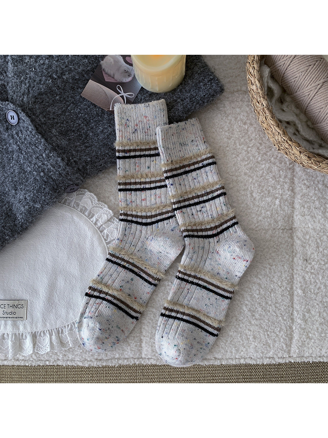 Ivory crew socks with black, brown and fuzzy beige stripes