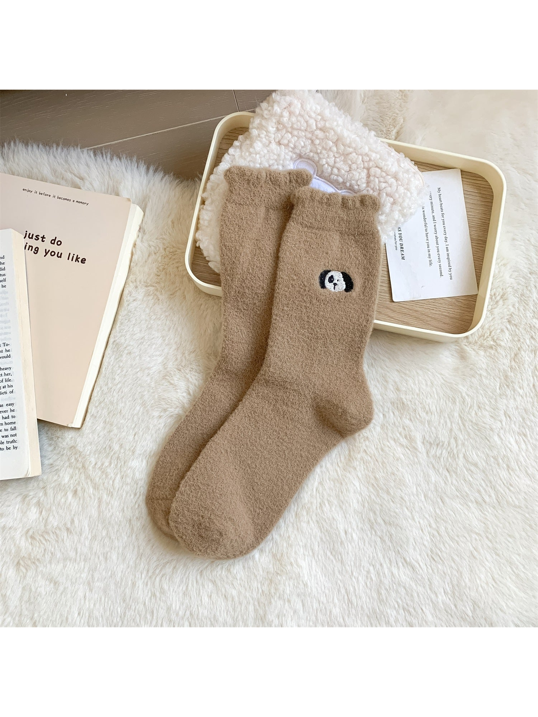 Light brown fuzzy crew socks with a small embroidered panda head motif