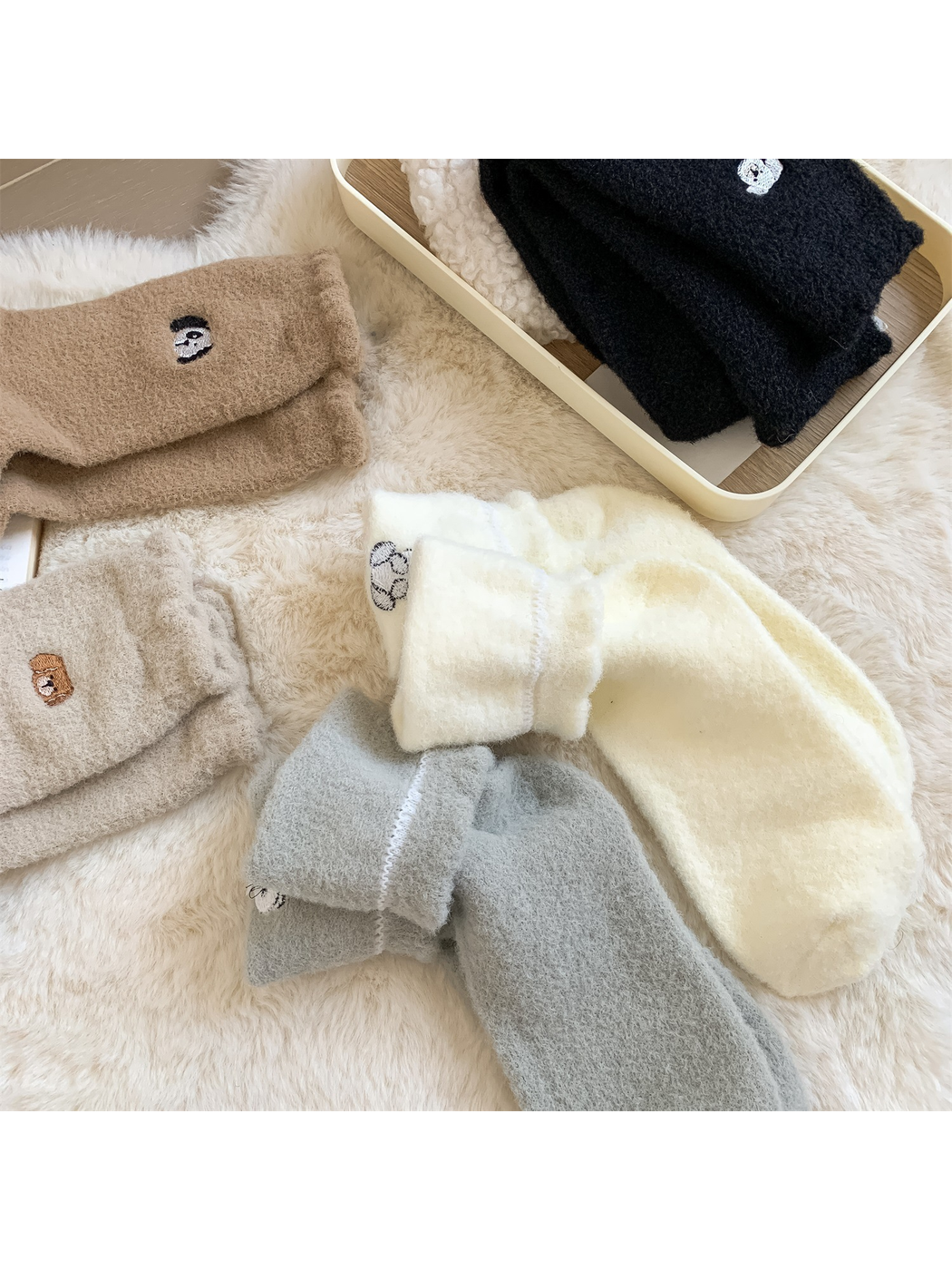 Turned fuzzy sock cuffs showing the interior seams and reverse of the embroidered motifs
