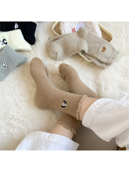 Light brown fuzzy crew socks worn in a relaxed indoor setting