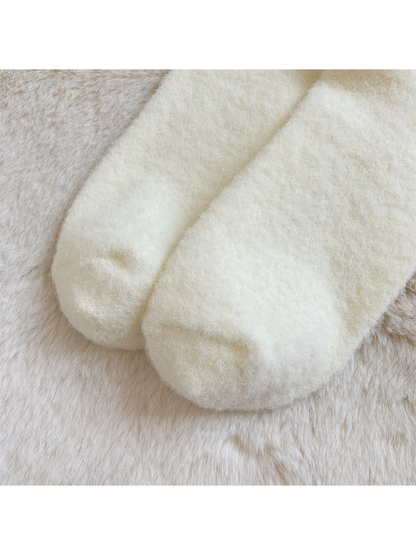 Close-up of the rounded toes and fine fuzzy texture of the ivory socks