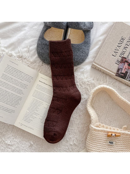Dark brown crew sock with alternating ribbed bands and diamond-knit motifs