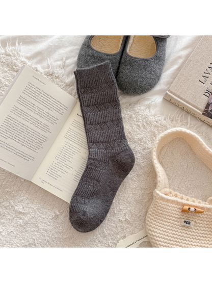 Dark gray crew sock with alternating ribbed bands and diamond-knit motifs