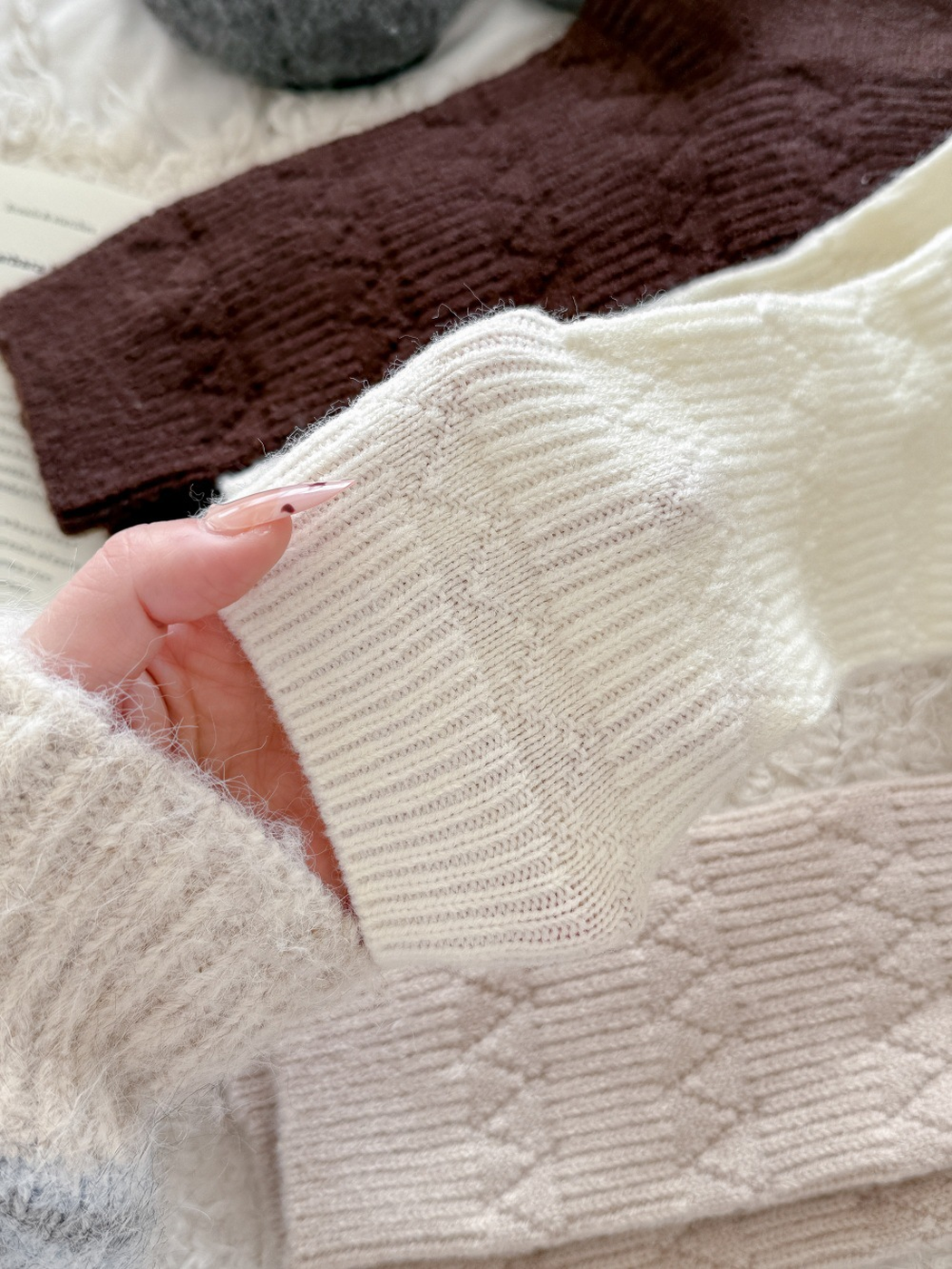 Close-up of the ribbed cuff and raised diamond-knit pattern