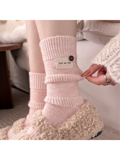 Pink ribbed crew socks worn with the fold-over bands turned outward