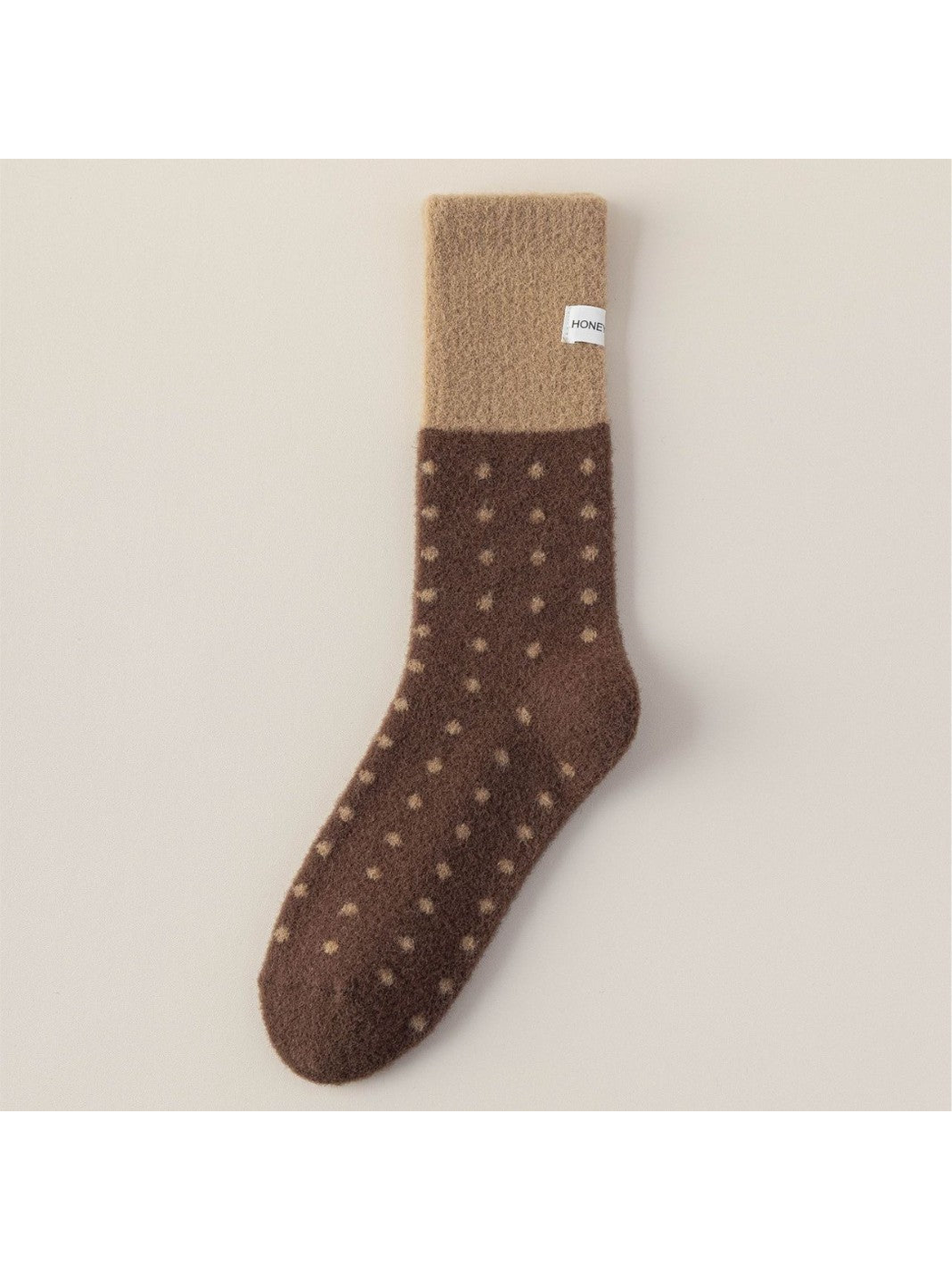 Dark brown fuzzy crew sock with camel cuff and polka dots